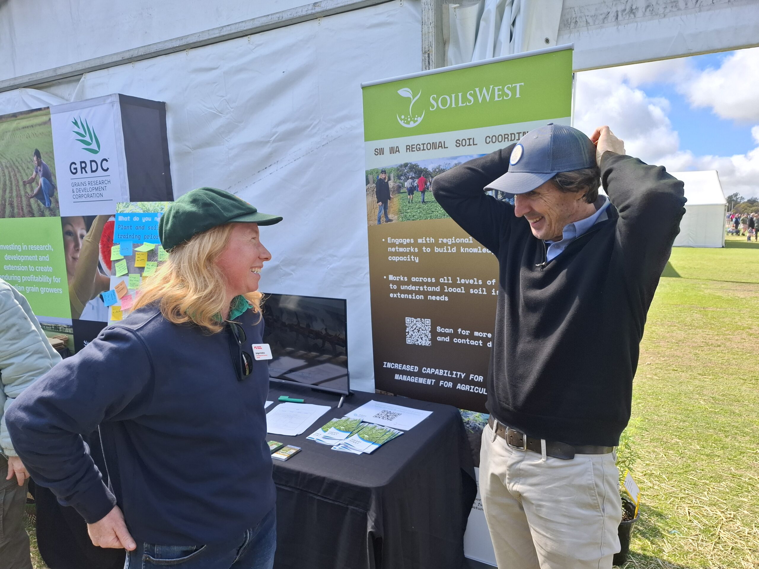 Regional Soil Coordinator Bridget Watkins swaps stories (and caps) with former Australian cricketer Brad Hogg at the 2025 Dowerin Machinery Field Days.